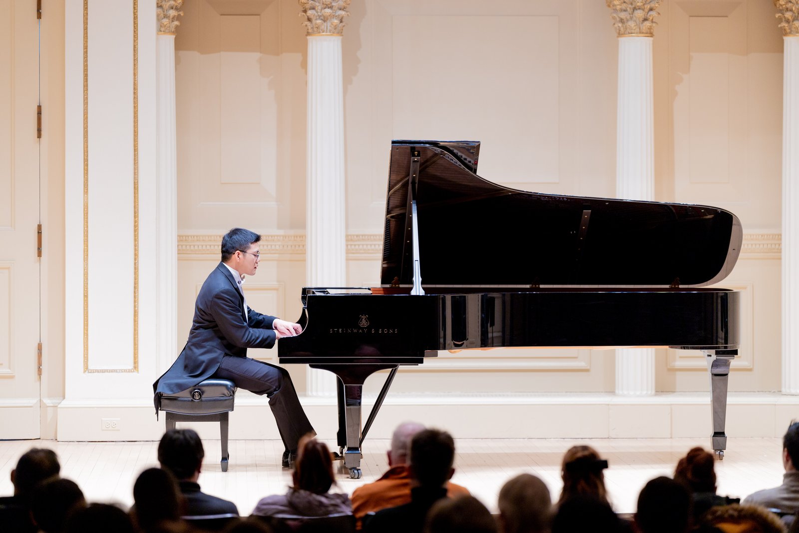 Bowen Duan performing at the grand piano in Carnegie Hall